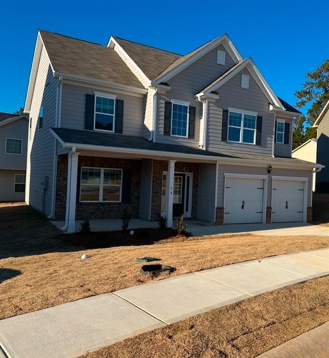 view of front of home with covered porch and a garage