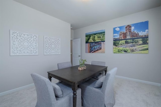 dining room featuring light carpet