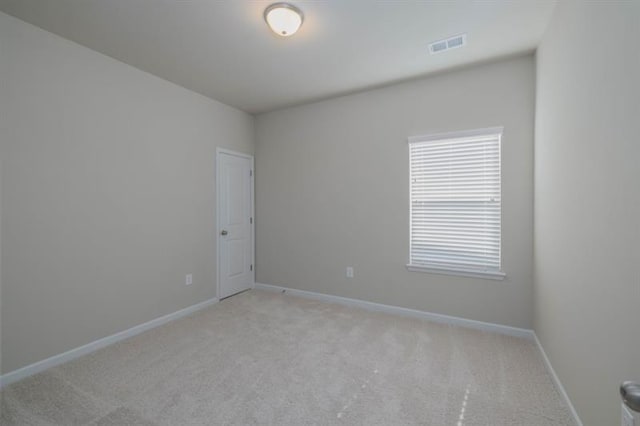 unfurnished room with light carpet