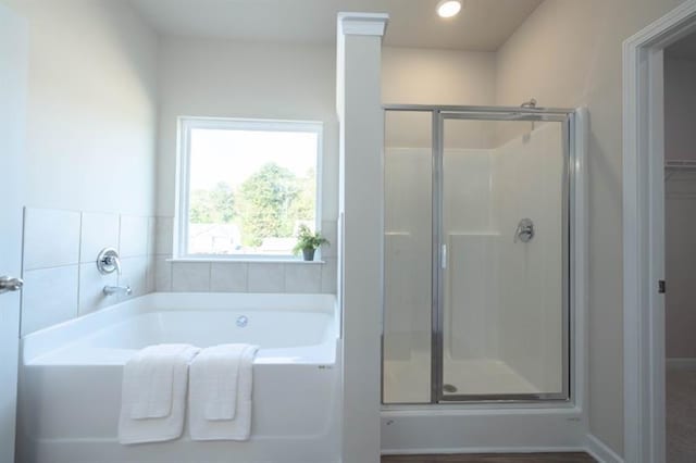 bathroom featuring separate shower and tub