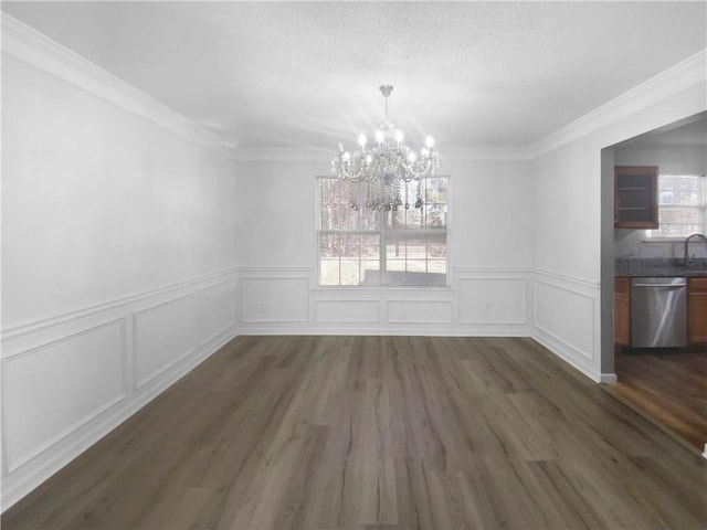 unfurnished dining area featuring dark wood-type flooring, crown molding, and a healthy amount of sunlight