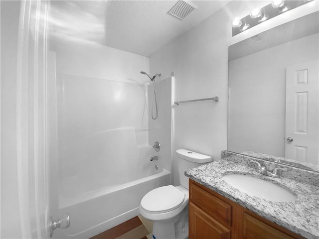 full bathroom with vanity, a textured ceiling, bathing tub / shower combination, and toilet