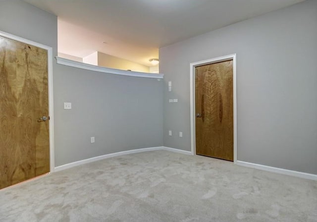 empty room with light carpet and lofted ceiling