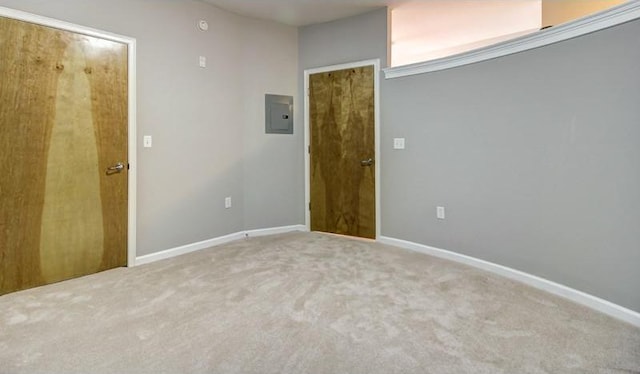 carpeted spare room featuring electric panel