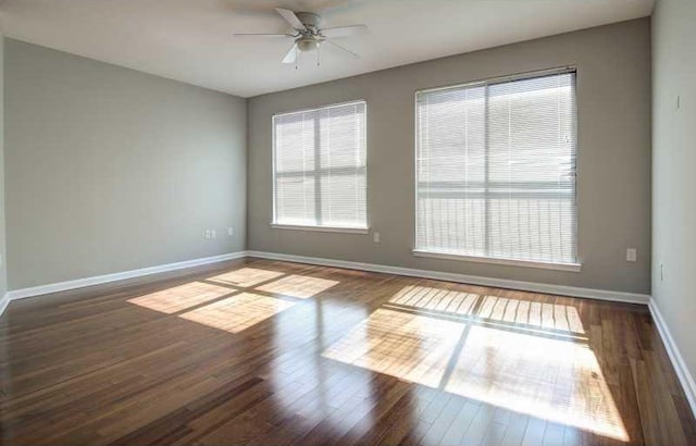 empty room featuring ceiling fan and dark wood-type flooring