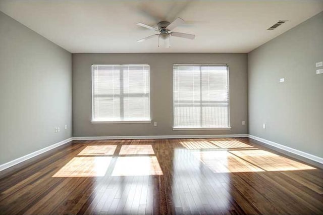 unfurnished room featuring ceiling fan and dark hardwood / wood-style flooring