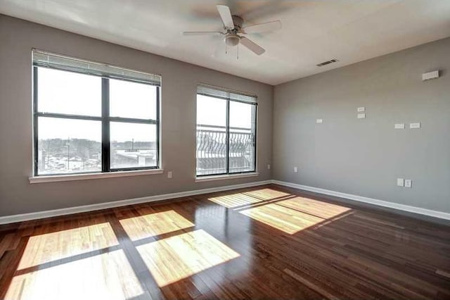 unfurnished room with ceiling fan and dark hardwood / wood-style floors