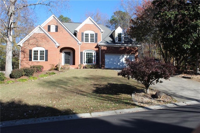 view of property featuring a garage and a front yard