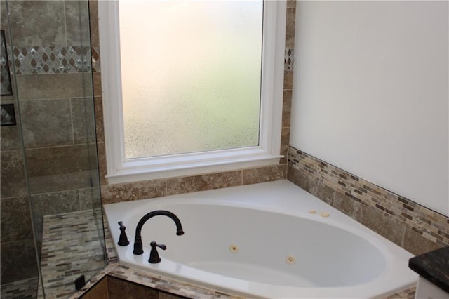 bathroom featuring a relaxing tiled tub