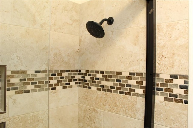 interior details with a tile shower