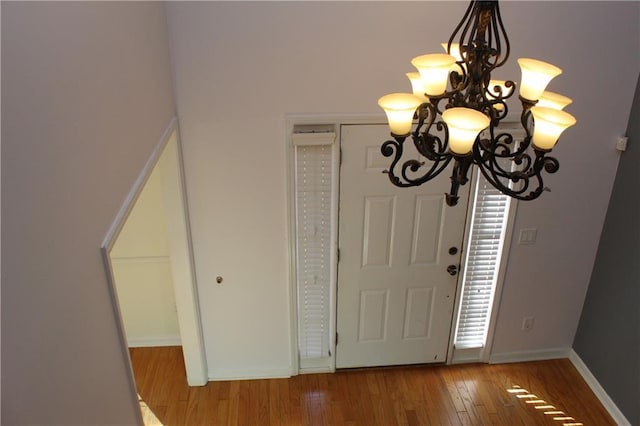 foyer featuring hardwood / wood-style flooring and a notable chandelier