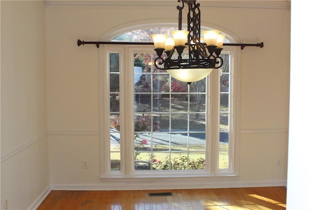 interior space featuring a chandelier and wood-type flooring