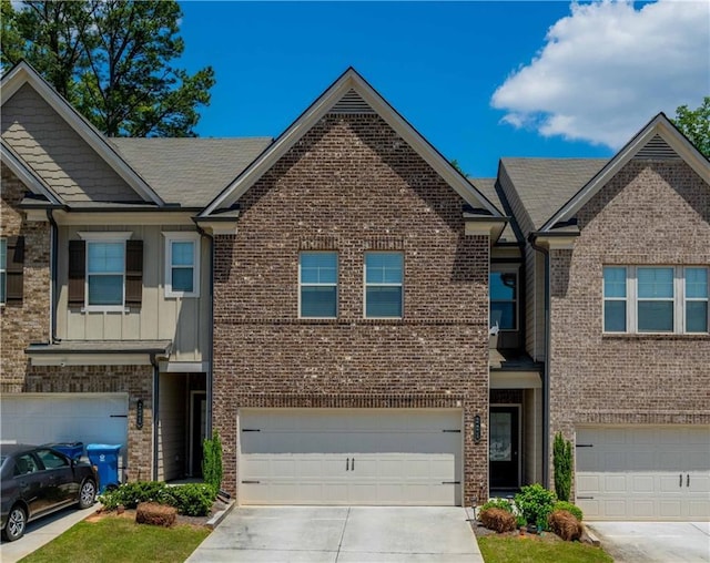 221 Irwell Path, Lawrenceville, GA 30044 - multi unit property with driveway, brick siding, board and batten siding, and an attached garage