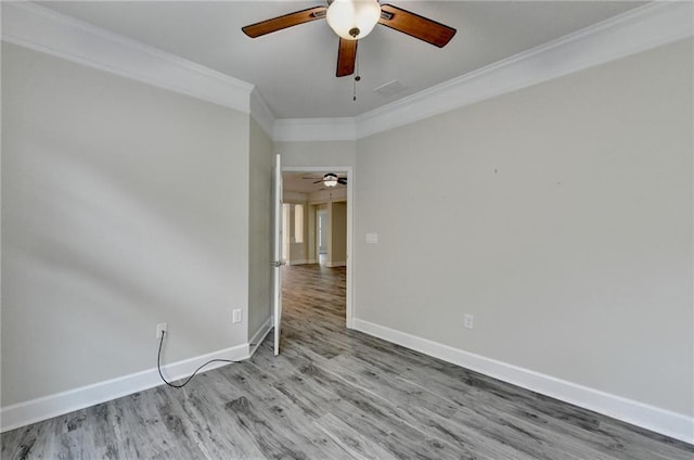 unfurnished room with baseboards, visible vents, a ceiling fan, ornamental molding, and wood finished floors