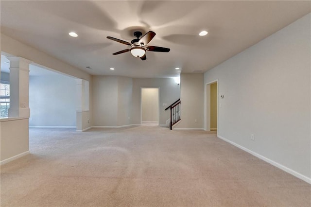 unfurnished room featuring ceiling fan, light colored carpet, recessed lighting, baseboards, and stairway