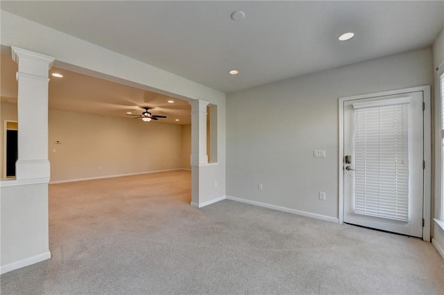 empty room with recessed lighting, ornate columns, light colored carpet, ceiling fan, and baseboards