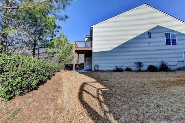 view of side of home with a deck