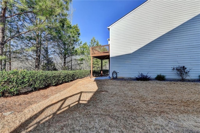 view of property exterior with a wooden deck