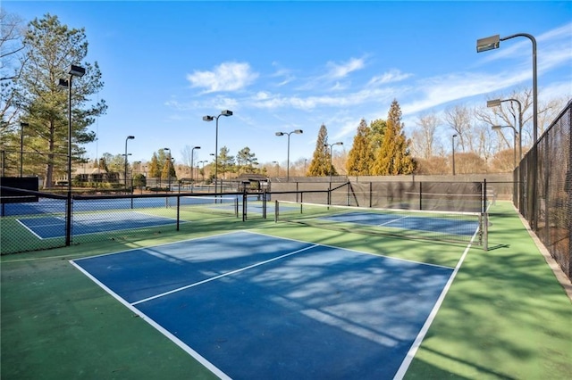 view of sport court featuring fence