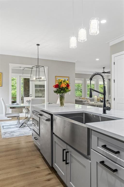 407 Estates View Dr, Acworth, GA 30101 - kitchen with gray cabinetry, a sink, light wood-style flooring, light countertops, and healthy amount of natural light