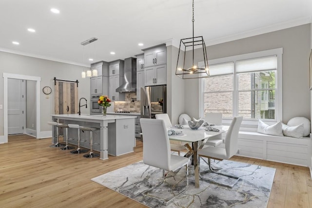 407 Estates View Dr, Acworth, GA 30101 - dining area featuring ornamental molding, a barn door, light wood finished floors, recessed lighting, and a chandelier