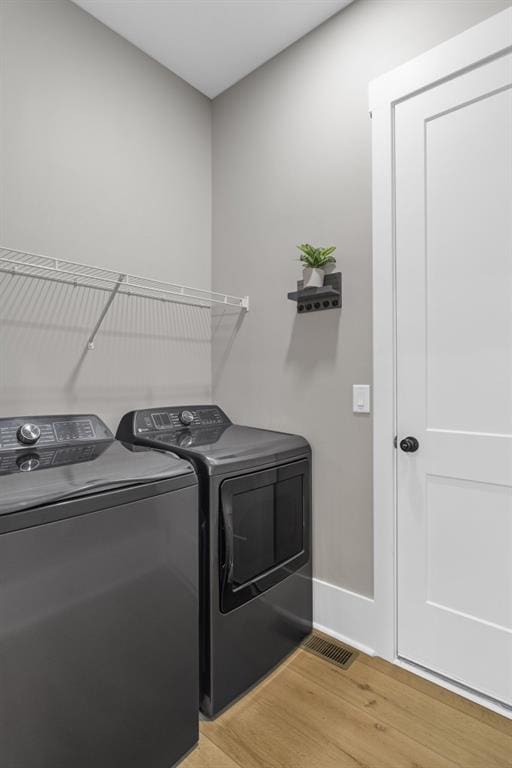 407 Estates View Dr, Acworth, GA 30101 - laundry area featuring washing machine and dryer, light wood-style flooring, and baseboards