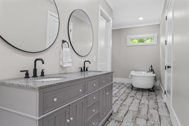 407 Estates View Dr, Acworth, GA 30101 - full bathroom featuring double vanity, a soaking tub, crown molding, baseboards, and marble finish flooring
