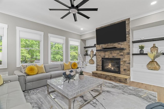407 Estates View Dr, Acworth, GA 30101 - living room with wood finished floors, a ceiling fan, crown molding, a stone fireplace, and recessed lighting