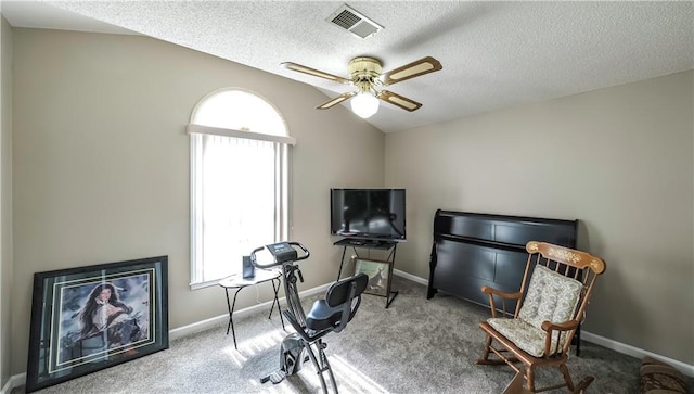 sitting room featuring ceiling fan, baseboards, lofted ceiling, carpet flooring, and visible vents