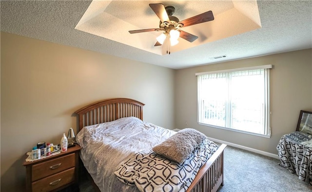 bedroom with visible vents, a textured ceiling, and carpet flooring