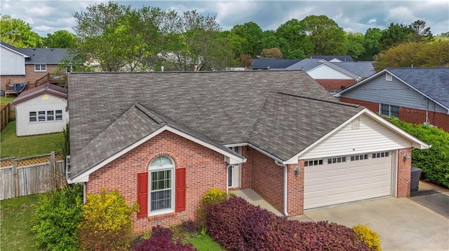 ranch-style house with an attached garage, driveway, fence, and brick siding