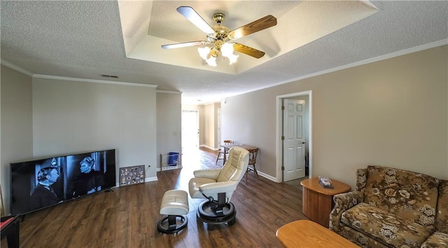 sitting room with a textured ceiling, visible vents, wood finished floors, ceiling fan, and crown molding