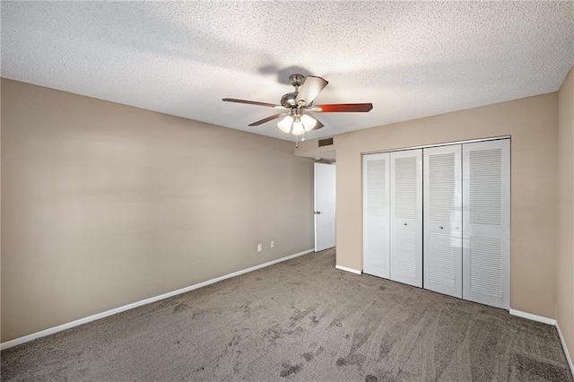 unfurnished bedroom featuring ceiling fan, carpet, a closet, and a textured ceiling