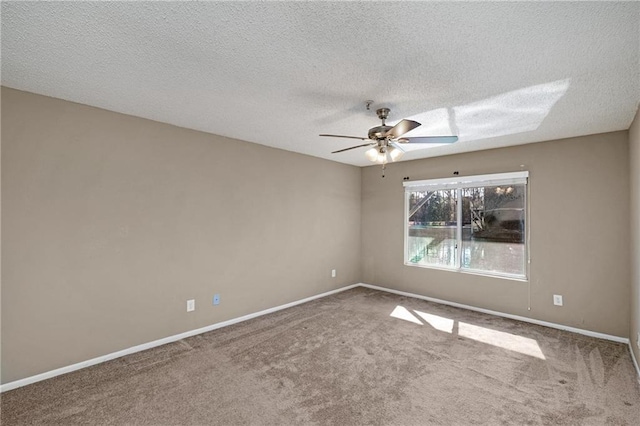 carpeted spare room with a textured ceiling and ceiling fan