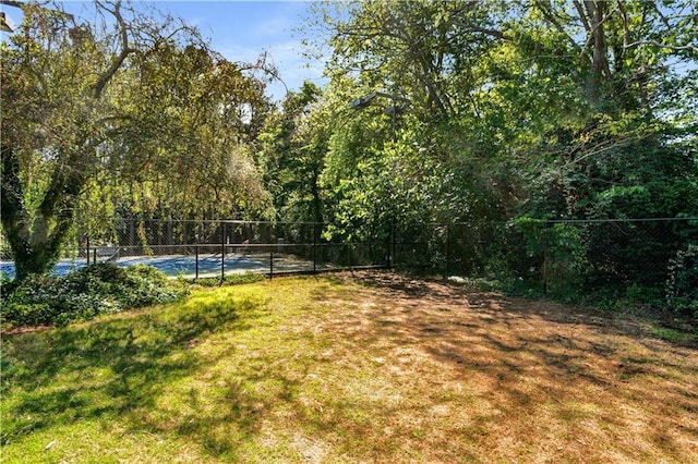 view of yard featuring tennis court