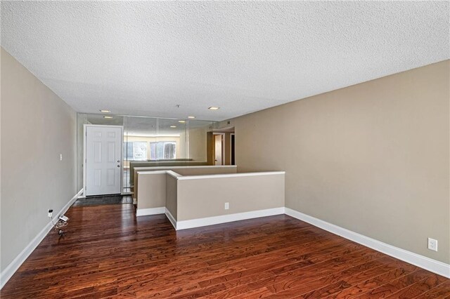 interior space with an inviting chandelier, dark hardwood / wood-style floors, and a textured ceiling