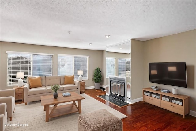 living room featuring hardwood / wood-style floors and a textured ceiling