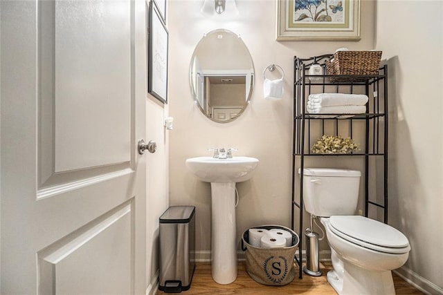 2294 Spicy Pine Ln, Lawrenceville, GA 30044 - half bath featuring wood finished floors, toilet, and baseboards