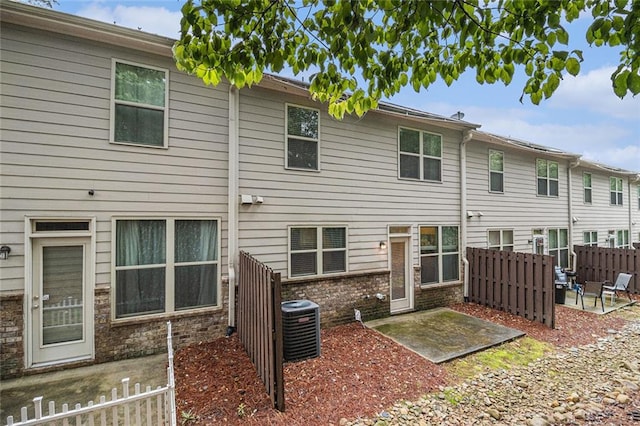 2294 Spicy Pine Ln, Lawrenceville, GA 30044 - back of house with a patio and central AC
