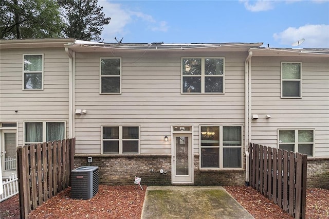 2294 Spicy Pine Ln, Lawrenceville, GA 30044 - back of property featuring central AC and a patio