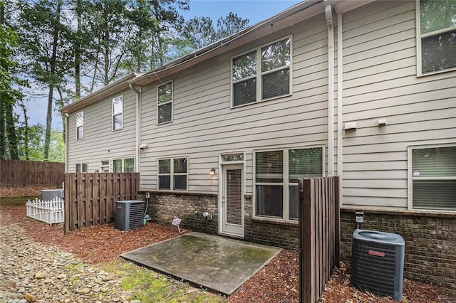 2294 Spicy Pine Ln, Lawrenceville, GA 30044 - back of property featuring central AC and a patio area
