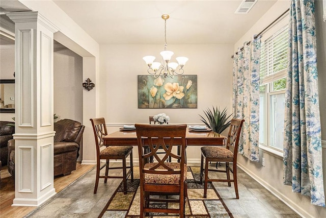 2294 Spicy Pine Ln, Lawrenceville, GA 30044 - dining area with ornate columns, a chandelier, and baseboards