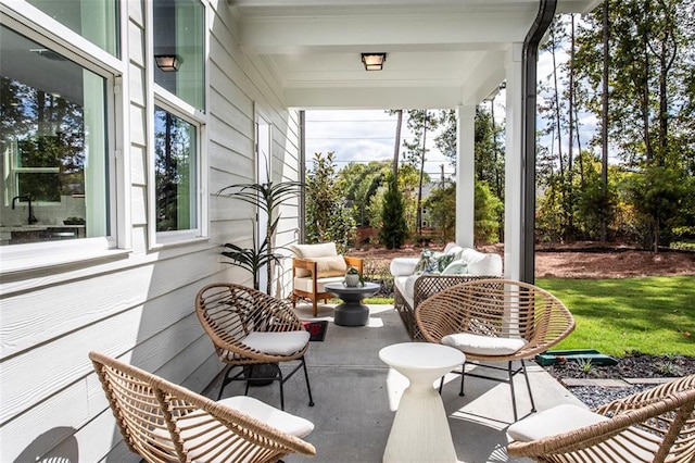 sunroom featuring beam ceiling