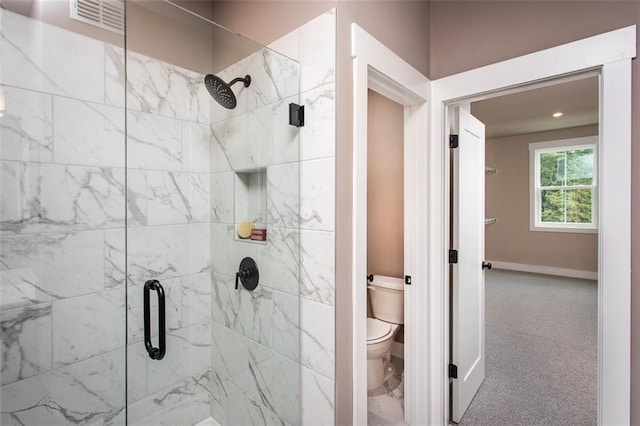 bathroom featuring walk in shower and toilet