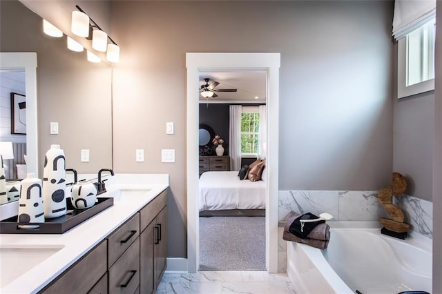 bathroom featuring a bathtub, vanity, and ceiling fan