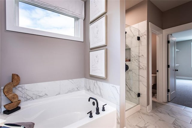 bathroom featuring toilet and separate shower and tub