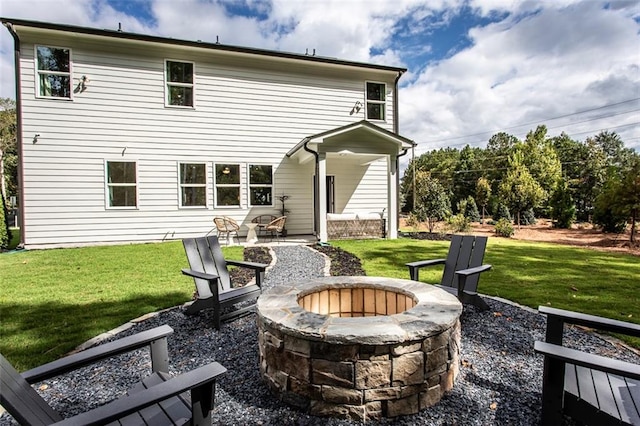 back of property featuring a patio, a yard, and a fire pit