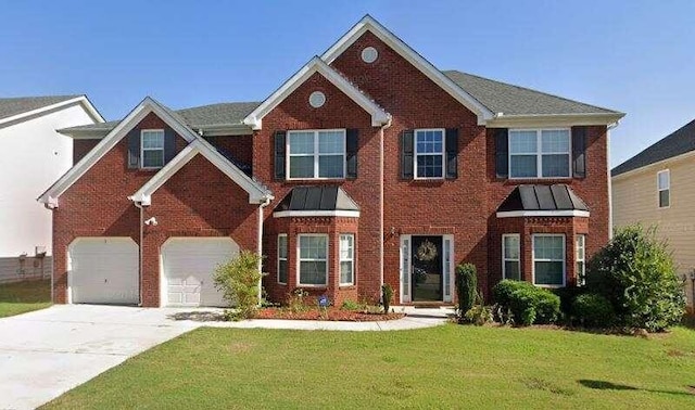 view of front of house with a garage and a front yard