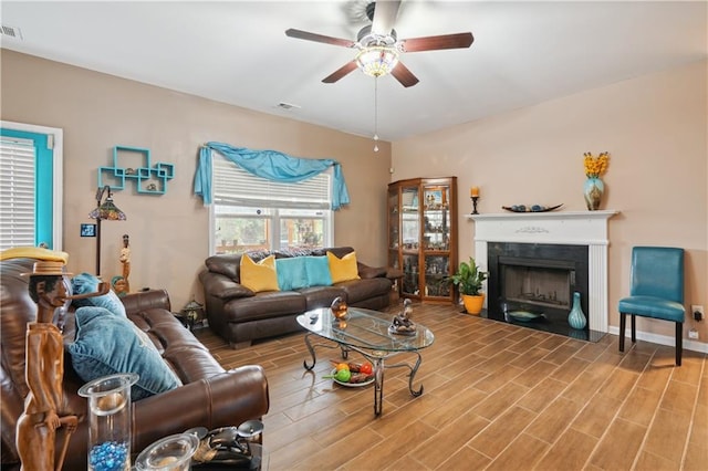 living room featuring ceiling fan and hardwood / wood-style floors