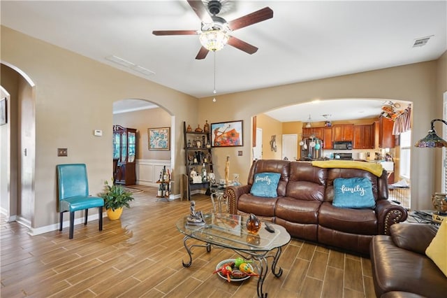 living room with ceiling fan and hardwood / wood-style floors